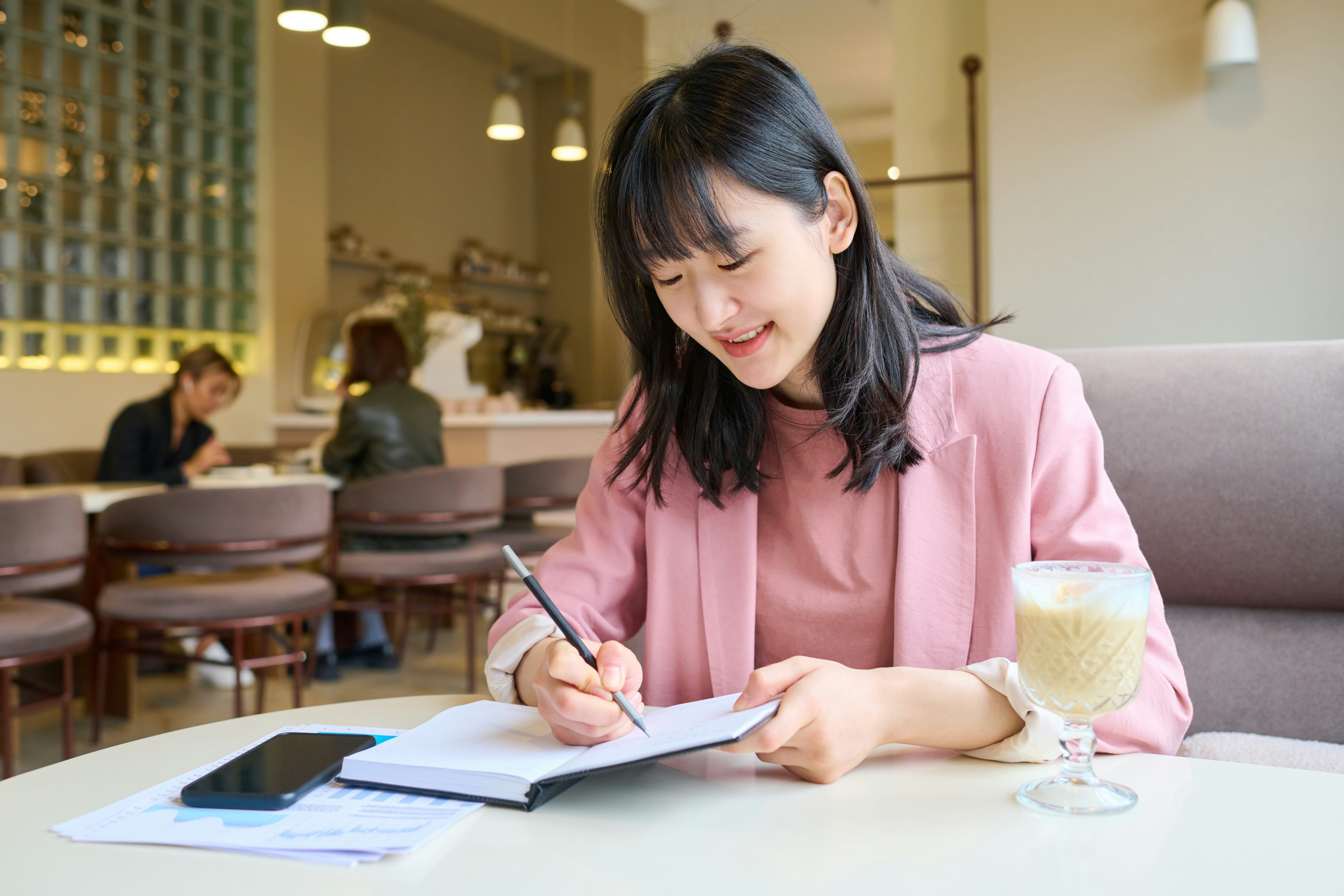 An open fund factsheet beside a notebook with three handwritten prompts: coverage, costs and overlap.